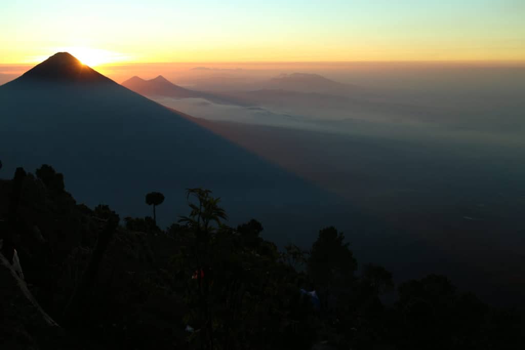 Sun rising behind Agua during Acatenango hike tour