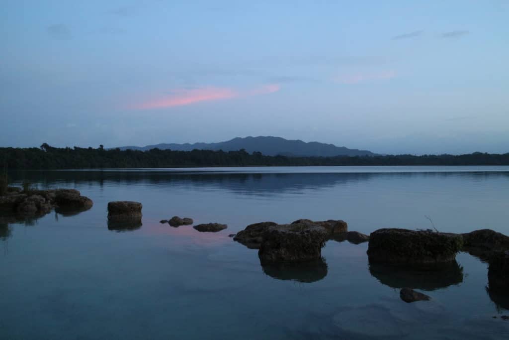 Rocks and pink clouds at Laguna Lachuá