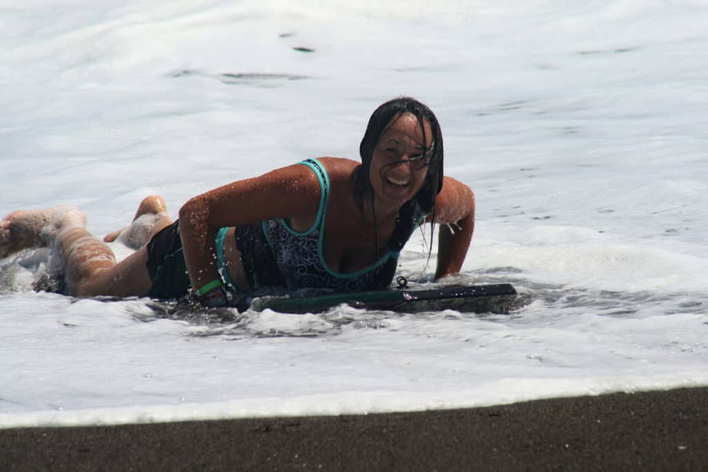 A friend enjoying the surf at Guatemala's black sand beach at Sipacate
