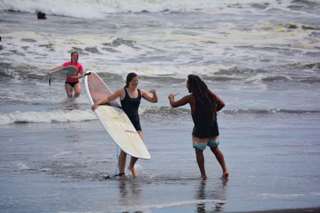 Fist-bump congratulations after a successful surfing session at El Paredón, one of Guatemala's nicest black sand beaches.