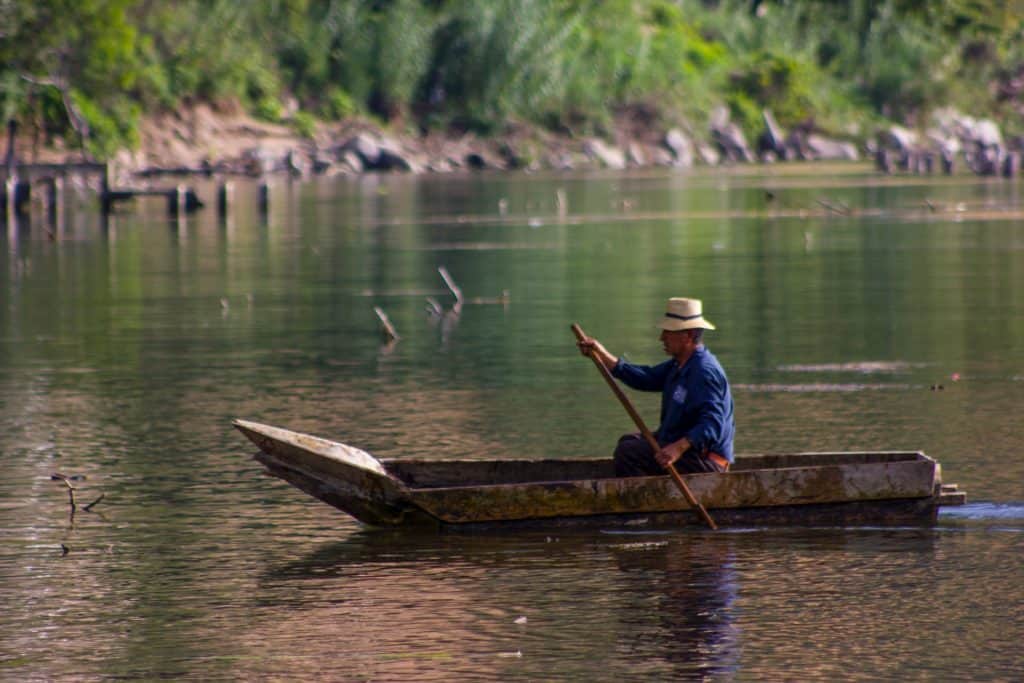 Man in a dugout canoe "cayuco" in San Juan la Laguna Guatemala