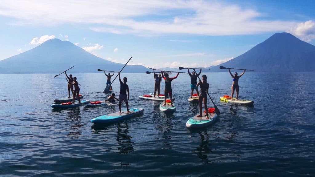 Group stand up paddle boarding on Lake Atitlán