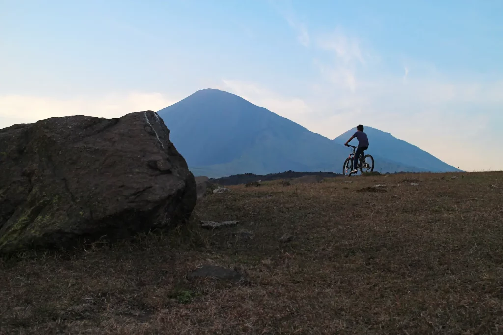 Diego on a bike in front of the volcanoes
