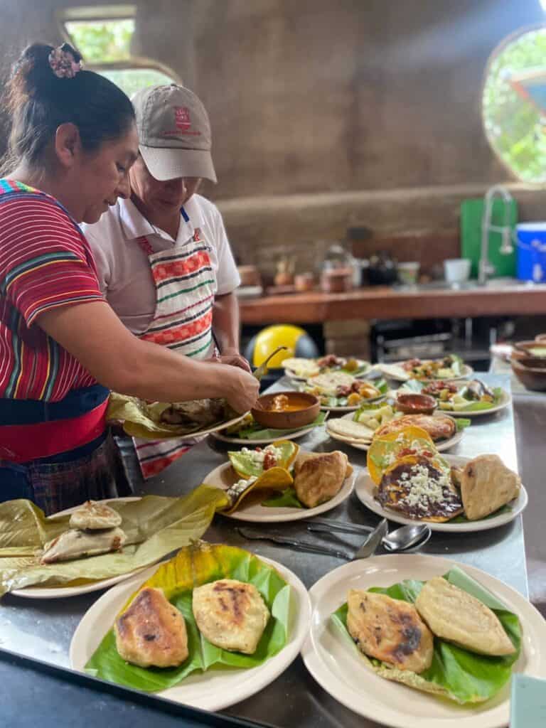 A Tzutujil Mayan woman prepares plates of traditional food.